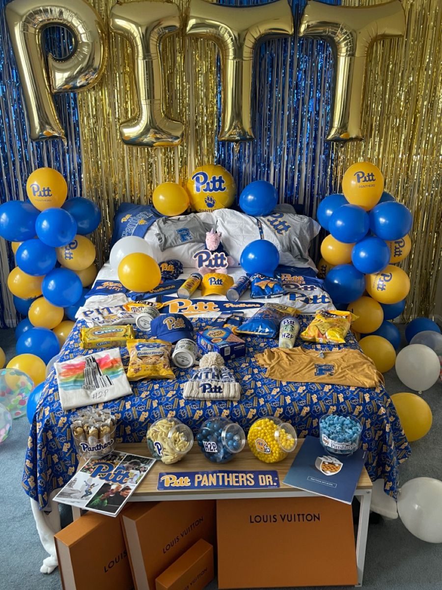 University of Pittsburgh bed party with PITT balloon letters, blue and gold decorations, and extensive Panthers merchandise