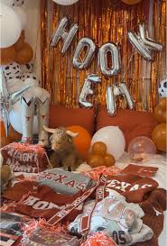 Texas Longhorns bed party with HOOK EM balloon letters, orange and brown decorations