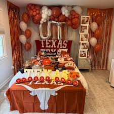 Texas Longhorns bed party with UT balloon letters, orange decorations, and Hook Em Horns merchandise