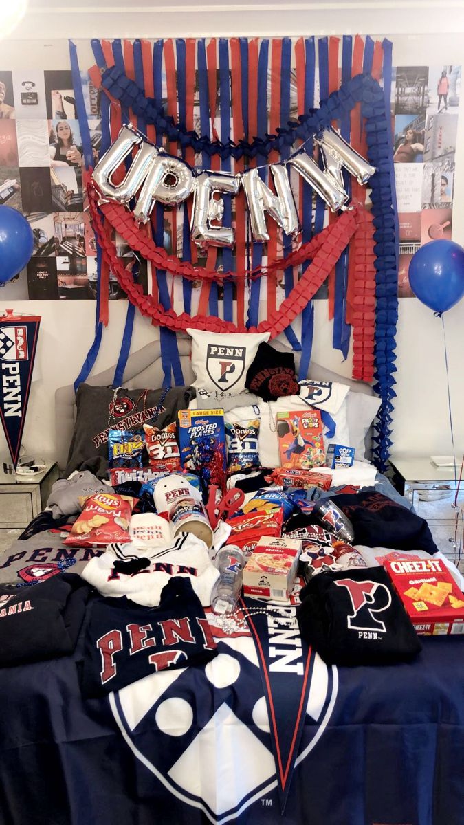 University of Pennsylvania bed party with UPENN balloon letters, red white and blue streamers, and extensive Penn merchandise
